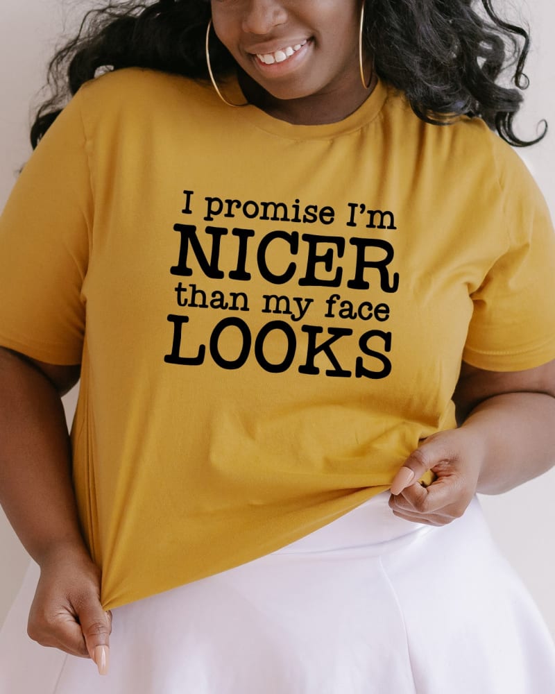 Front of a model wearing a size 2XL I'm Nicer Than My Face Looks in Mustard by Simply Sage Market. | dia_product_style_image_id:281503